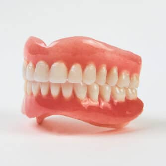 Artificial,Teeth,On,A,White,Background,With,Copy,Space.,Full